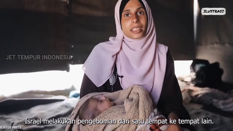 乳児を抱き抱える女性、紛争による人道危機を示唆